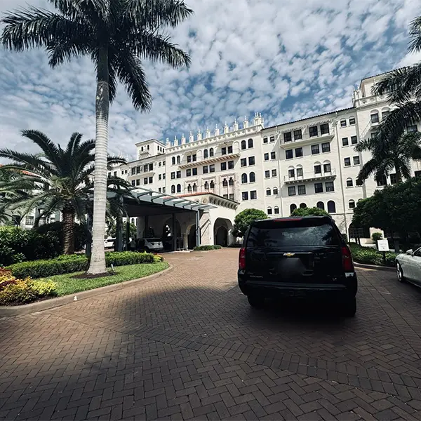 Black SUV parked in front of the iconic Boca Raton Club at 501 East Camino Real, representing Miami Premier Transportation's luxury services in Boca Raton