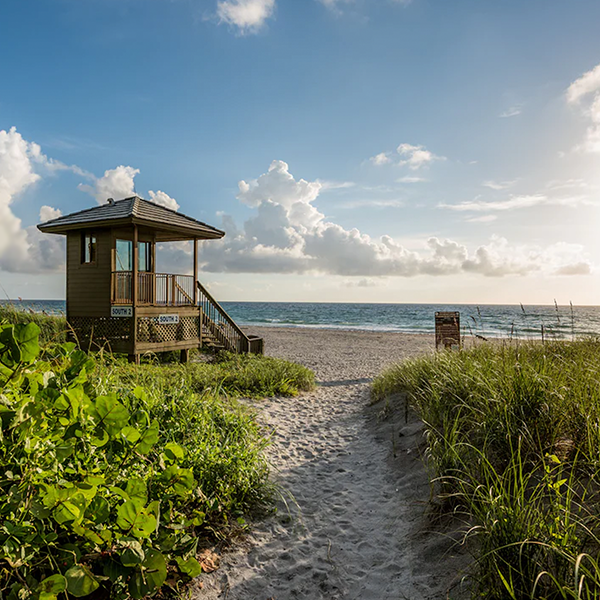 Beautiful Delray Beach shoreline with clear blue waters and sandy beaches, highlighting a popular destination serviced by Miami Premier Transportation