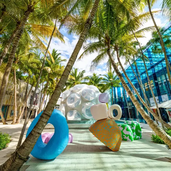 Street view of Miami's Design District with modern architecture and luxury stores, representing a popular destination served by Miami Premier Transportation