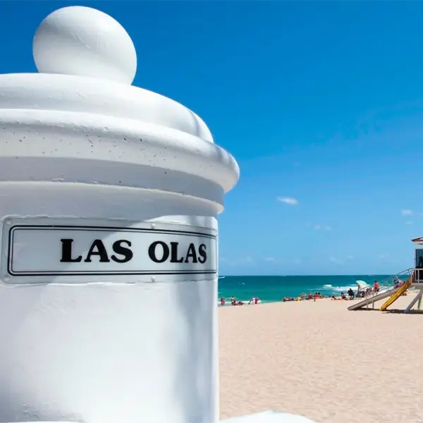 Las Olas sign with the beach in the background, highlighting a popular Fort Lauderdale destination served by Miami Premier Transportation