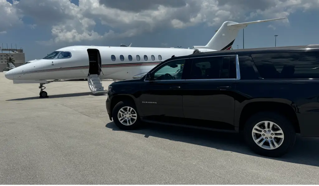 Luxury SUV parked in front of a private jet waiting for a VIP traveler, representing Miami Premier Transportation’s exclusive private jet services